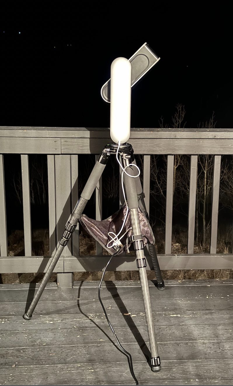 A Vespera smart telescope on a carbon-fiber tripod imaging under the night sky from a deck in South Park, Colorado